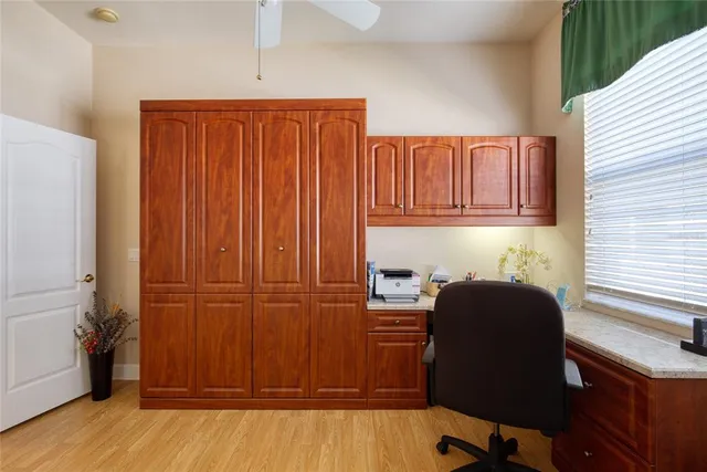 an aerial view of a city with lots of residential buildings and mountain view in back