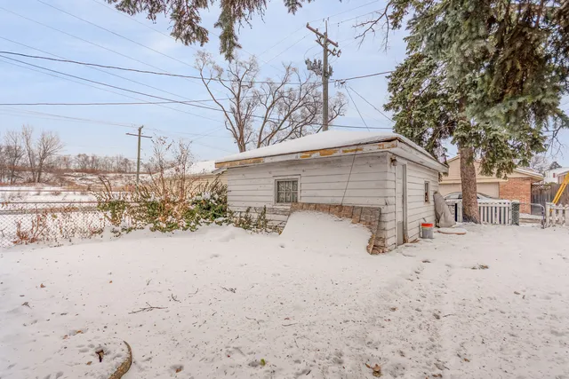 a view of a house with a snow in the yard