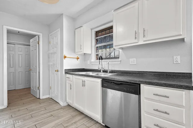 a kitchen with granite countertop a stove and a refrigerator