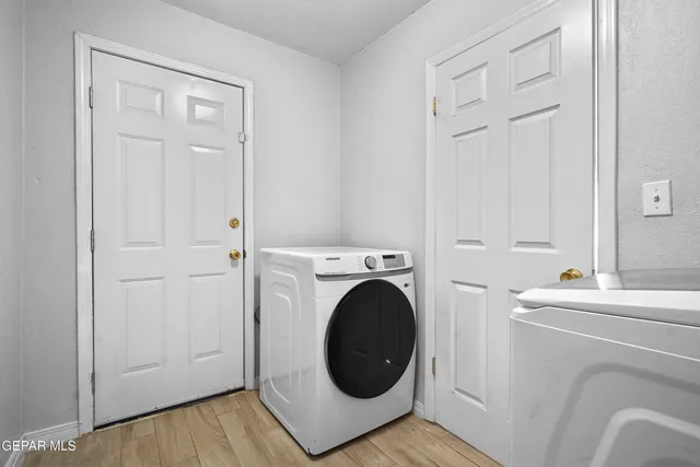 an empty room with closet and windows