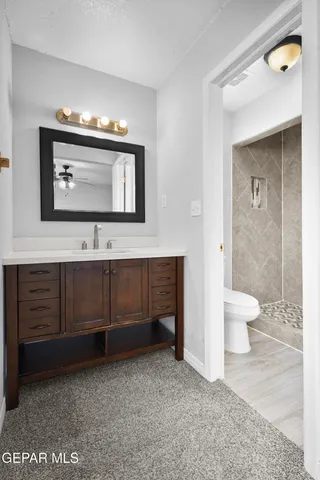 a bathroom with a toilet and a shower