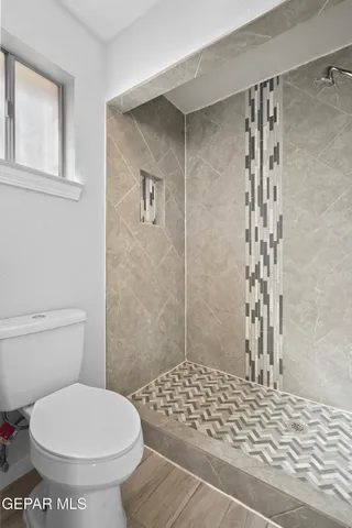 a bathroom with a sink vanity mirror toilet and bathtub