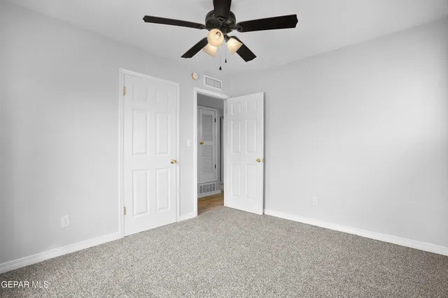 a view of a house with backyard and tree