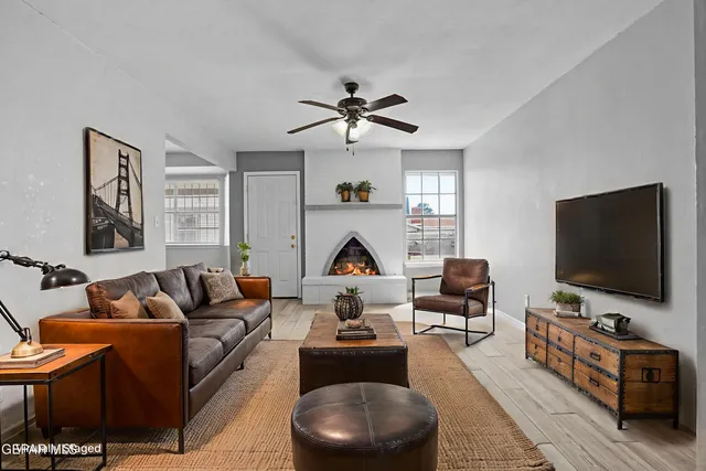 a living room with furniture and a flat screen tv