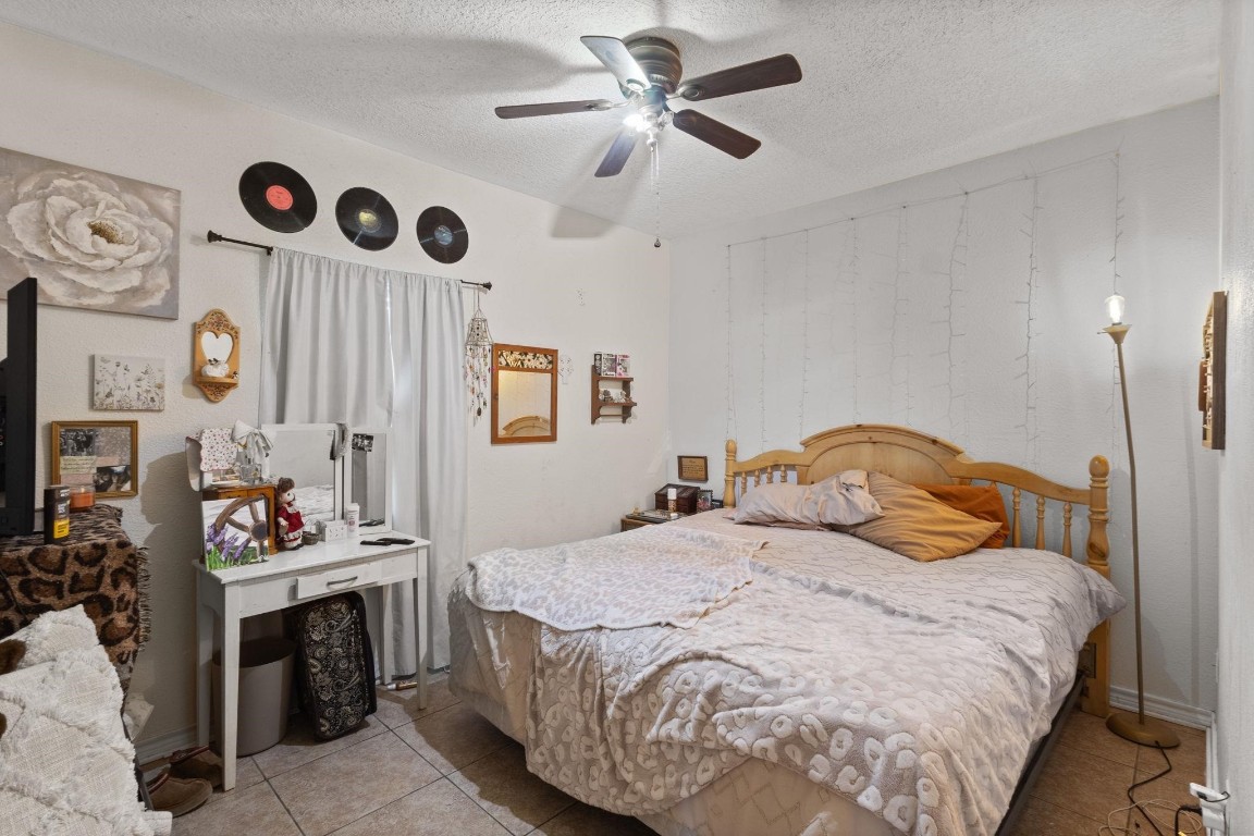 770 Katherene Avenue Bridge City, TX 77611 - Photo 13 of 29 a bedroom with a bed and a chandelier