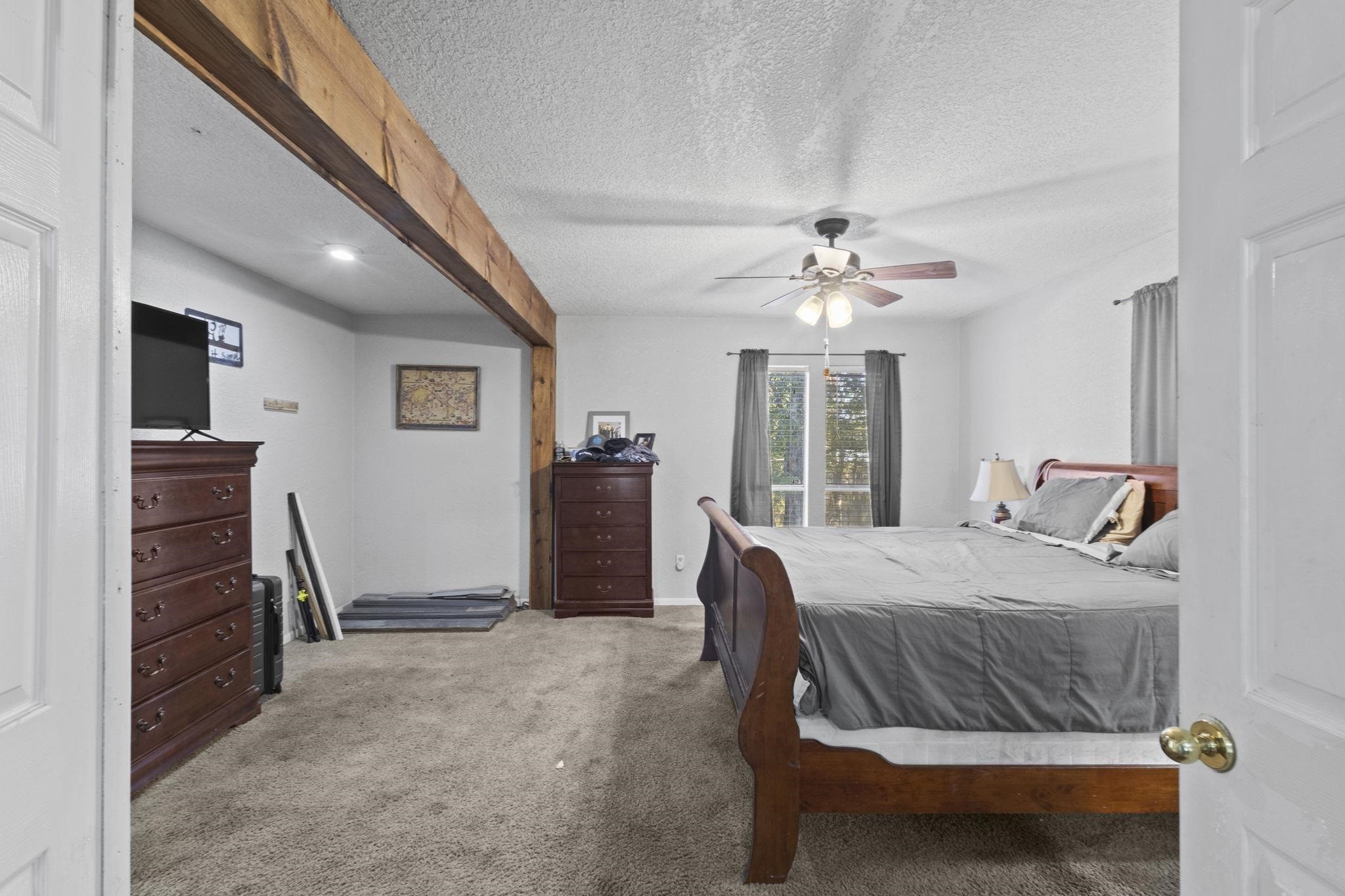 770 Katherene Avenue Bridge City, TX 77611 - Photo 17 of 29 a bedroom with a bed and a chandelier