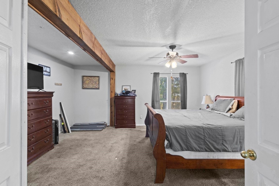 770 Katherene Avenue Bridge City, TX 77611 - Photo 19 of 29 a bedroom with a bed and a chandelier