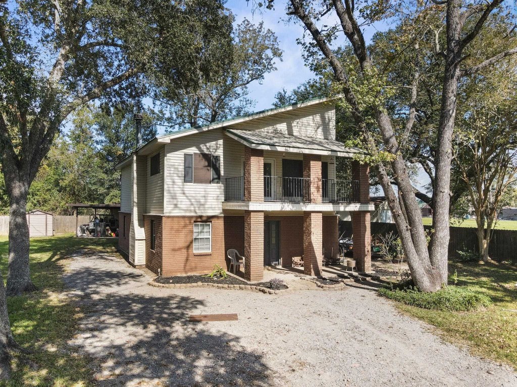 770 Katherene Avenue Bridge City, TX 77611 - Photo 4 of 29 a view of a blue house with yard and a tree