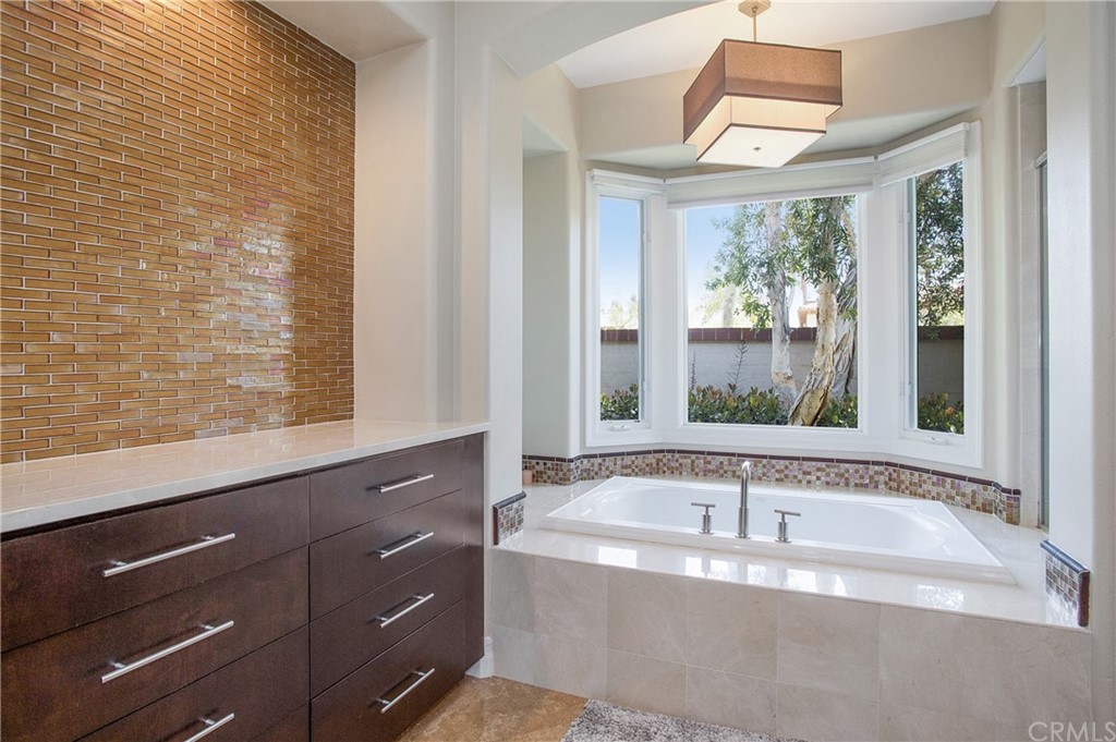 2395 Horizon Way Tustin, CA 92782 - Photo 16 of 39 a bath tub sitting in a bathroom next to a window