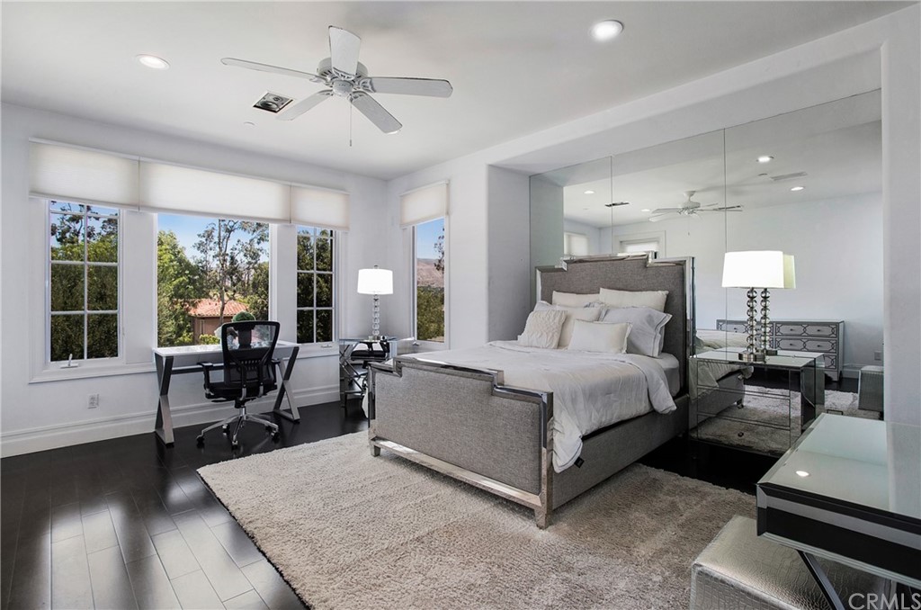 2395 Horizon Way Tustin, CA 92782 - Photo 19 of 39 a spacious bedroom with a bed a table and large window