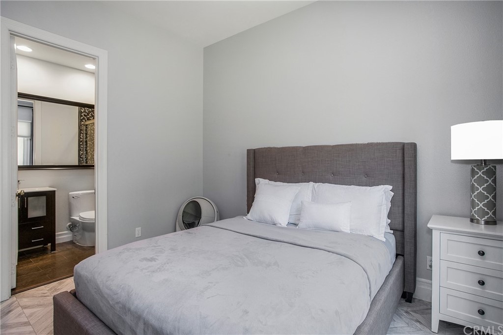 2395 Horizon Way Tustin, CA 92782 - Photo 25 of 39 a bedroom with a bed and a fireplace