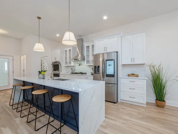 a kitchen with refrigerator cabinets and wooden floor