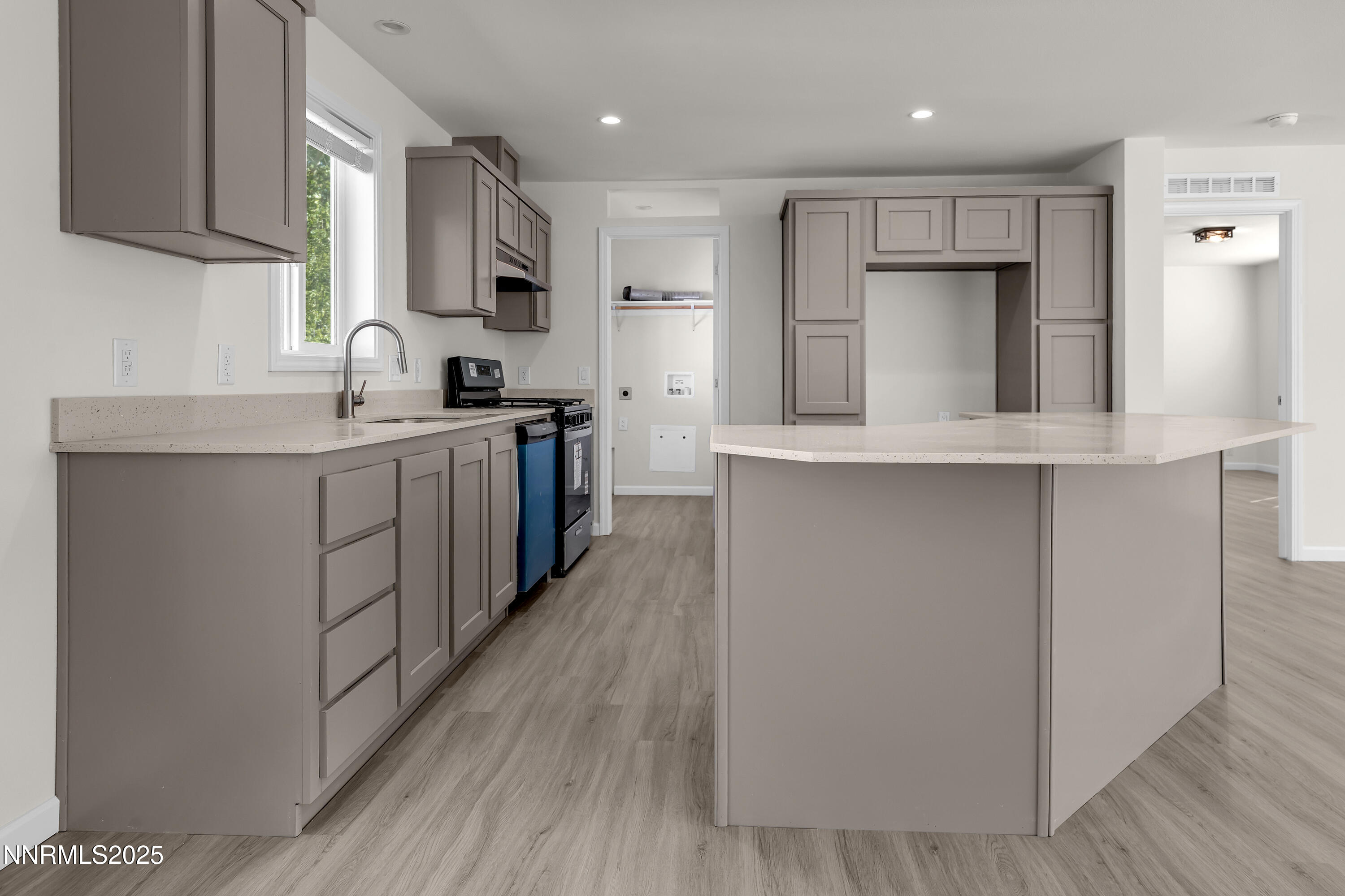 3810 Bobolink Circle Reno, NV 89508 - Photo 12 of 36 a kitchen with stainless steel appliances a sink cabinets and wooden floor