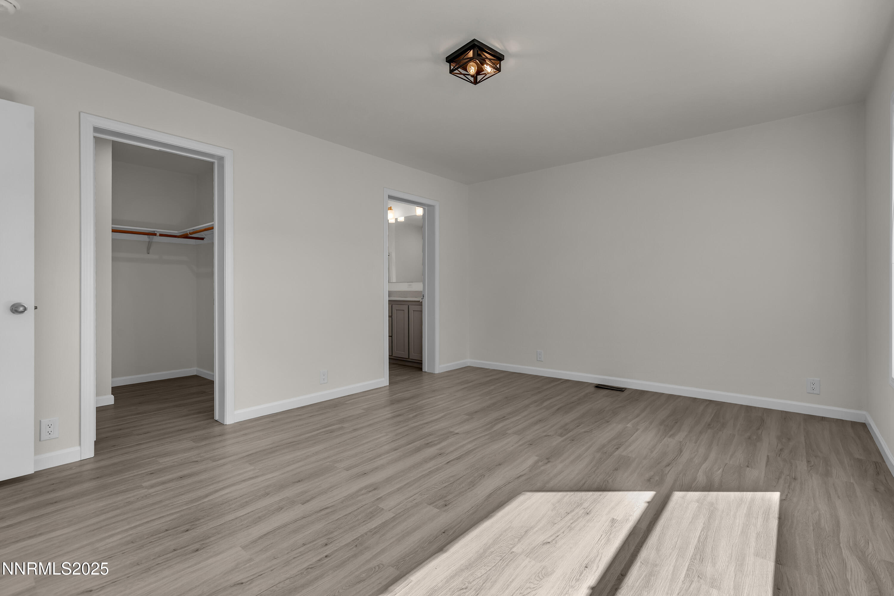 3810 Bobolink Circle Reno, NV 89508 - Photo 14 of 36 an empty room with wooden floor and closet