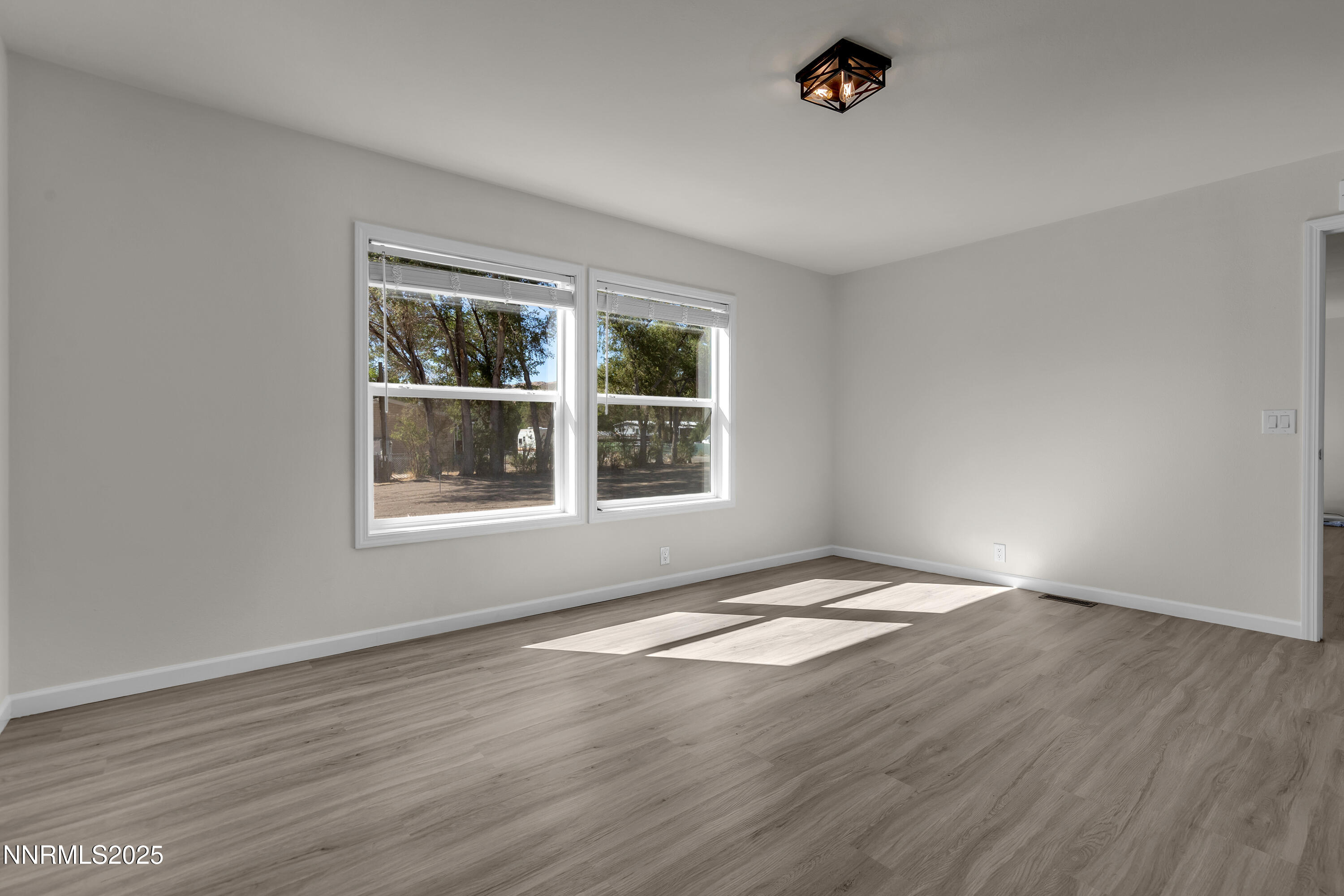 3810 Bobolink Circle Reno, NV 89508 - Photo 15 of 36 a view of an empty room with wooden floor and a window