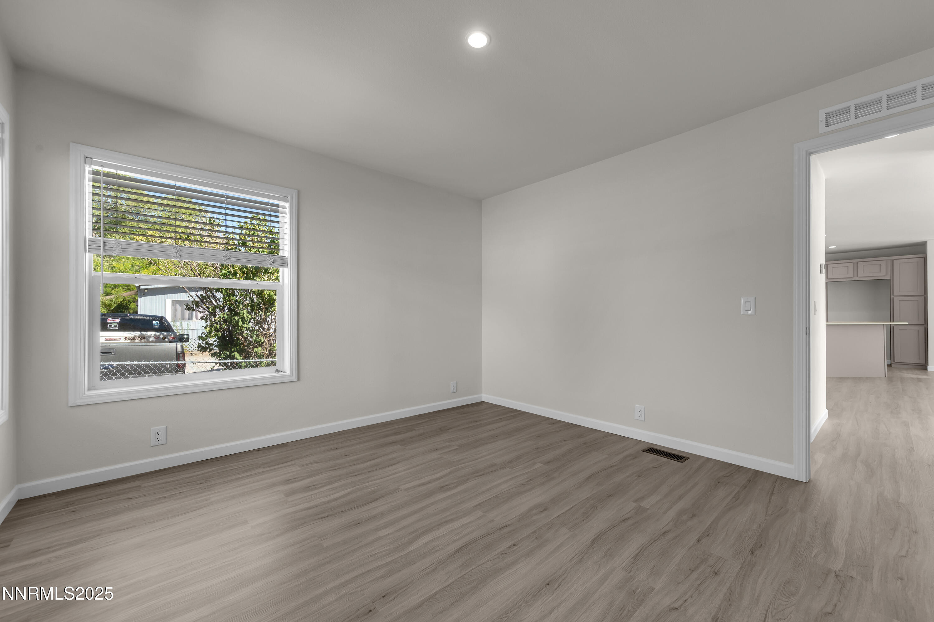 3810 Bobolink Circle Reno, NV 89508 - Photo 23 of 36 a view of an empty room with wooden floor and a window