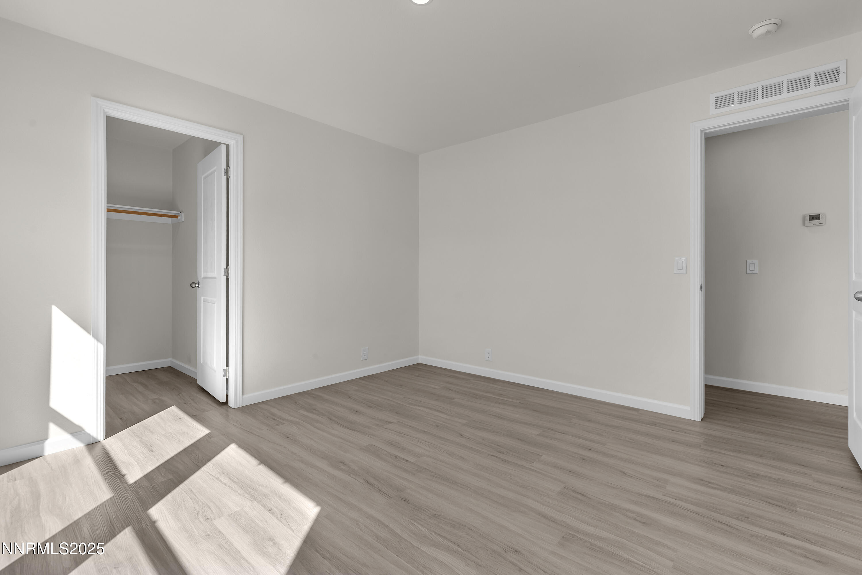 3810 Bobolink Circle Reno, NV 89508 - Photo 25 of 36 an empty room with wooden floor and windows