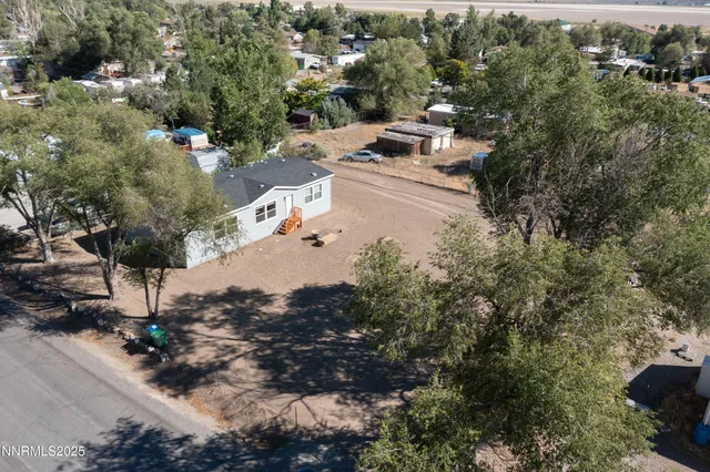 an aerial view of multiple houses with yard