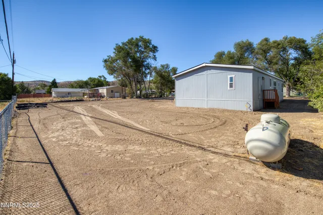a view of a white house with a yard