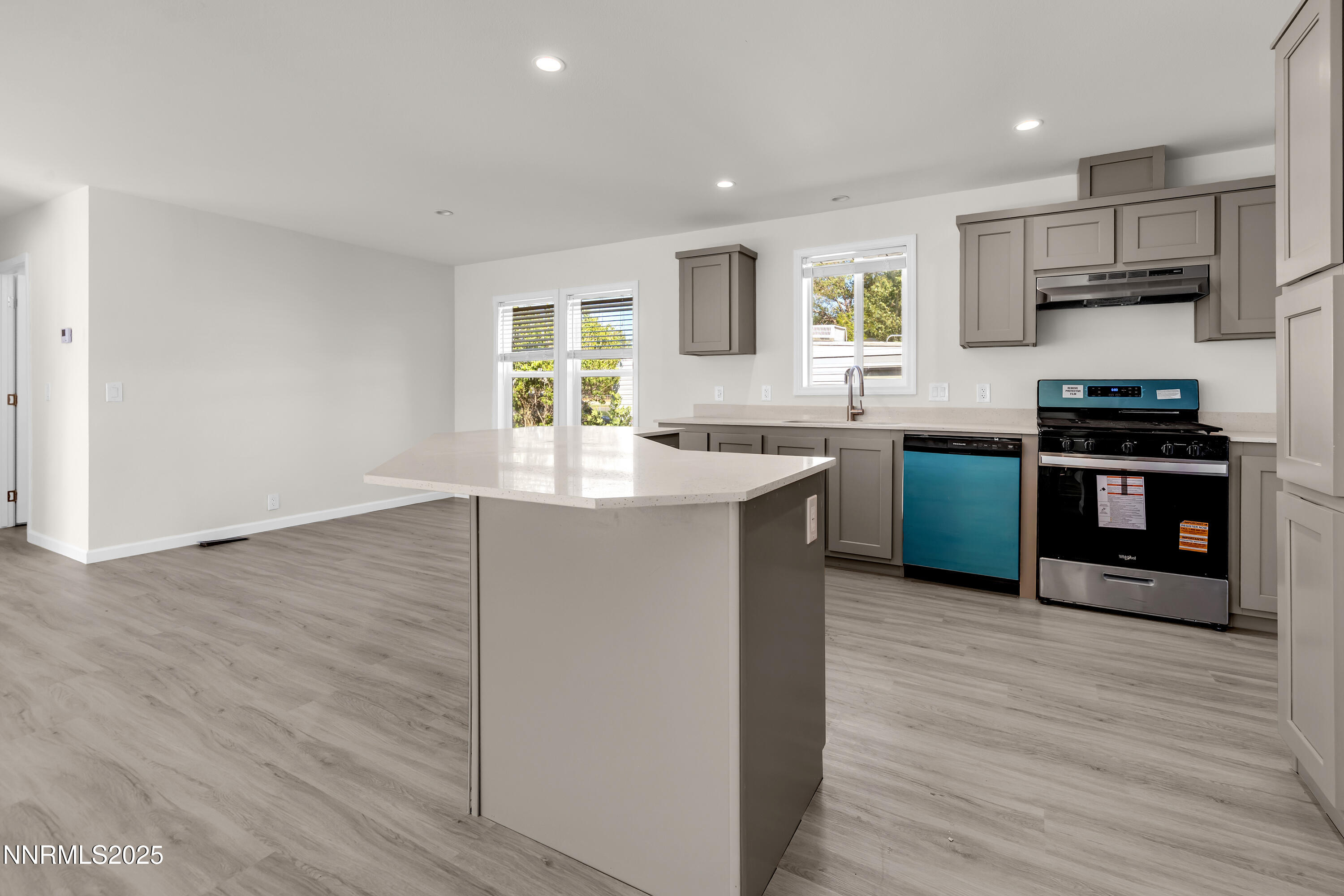 3810 Bobolink Circle Reno, NV 89508 - Photo 6 of 36 a kitchen with stainless steel appliances granite countertop a sink stove and wooden floor