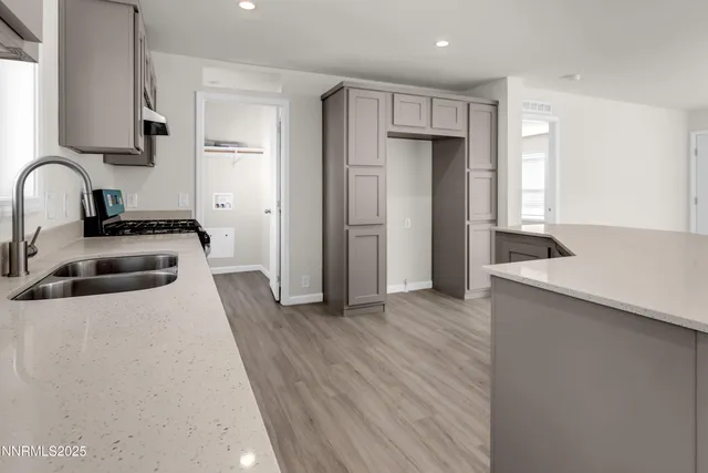 a kitchen with stainless steel appliances a refrigerator a sink a stove and cabinets