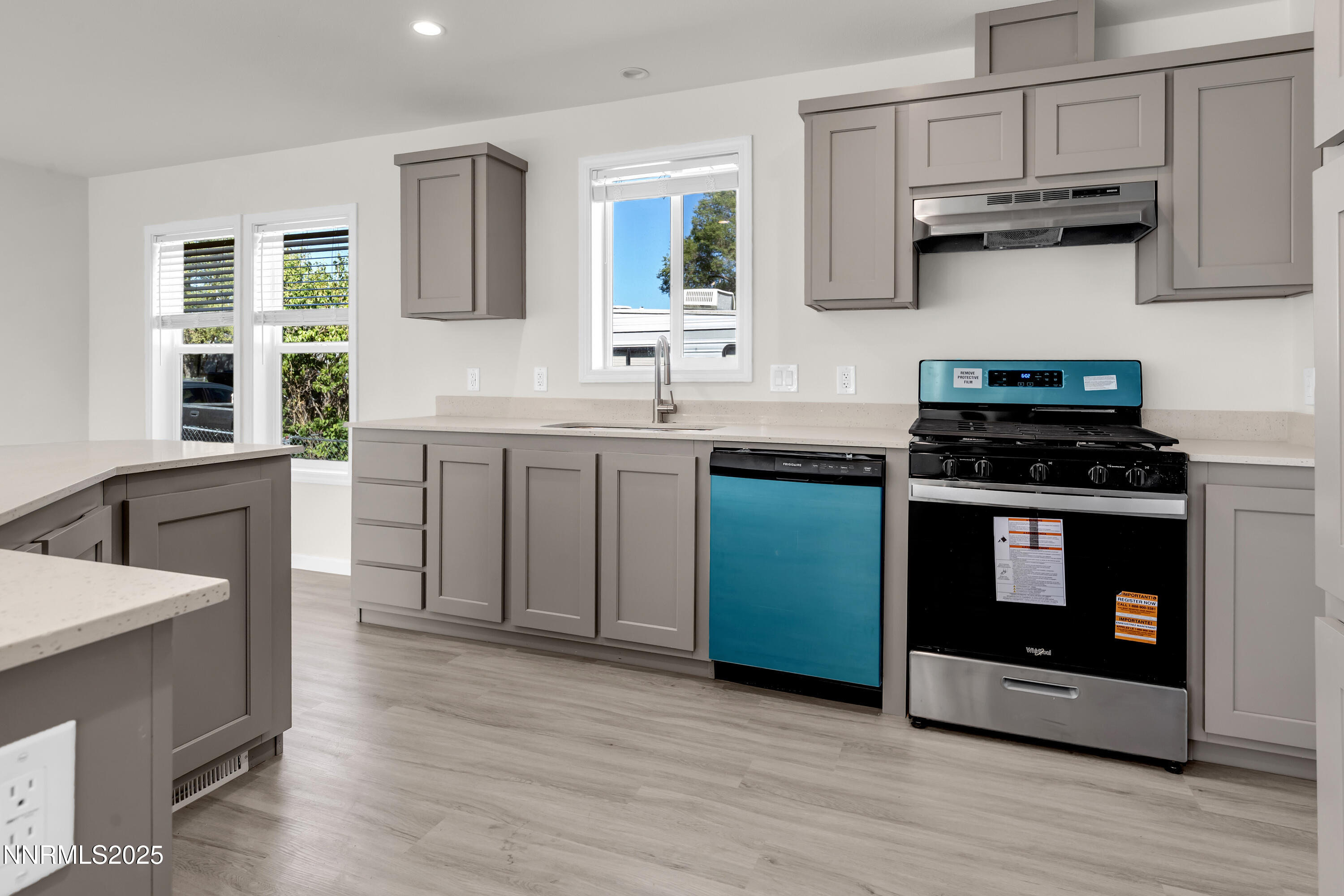 3810 Bobolink Circle Reno, NV 89508 - Photo 8 of 36 a kitchen with stainless steel appliances a stove sink and cabinets