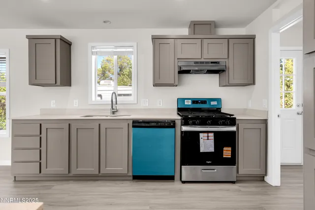 a kitchen with stainless steel appliances granite countertop a stove and a sink