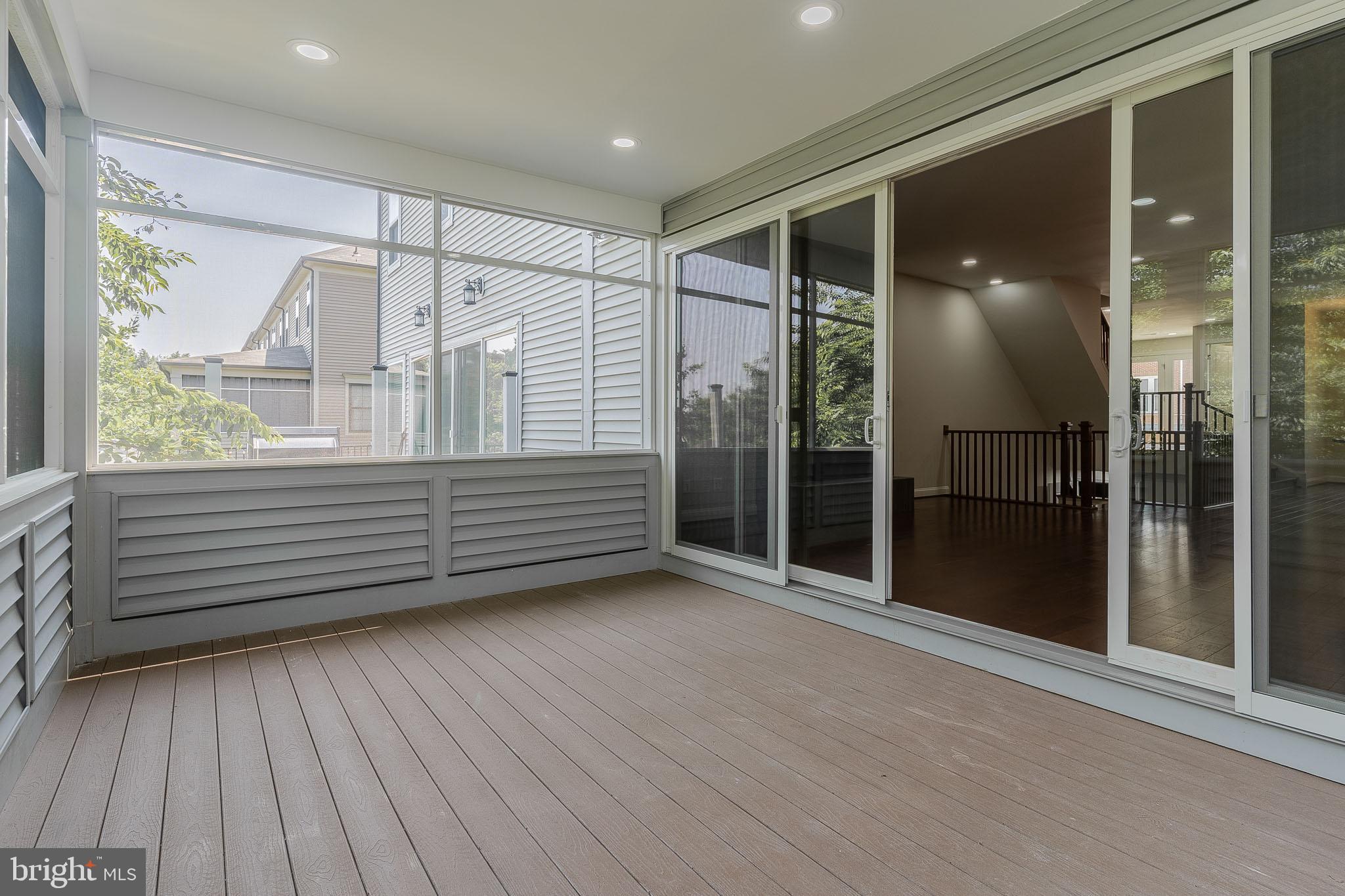 23480 Epperson Square Brambleton, VA 20148 - Photo 16 of 50 a view of an empty room with wooden floor and a window