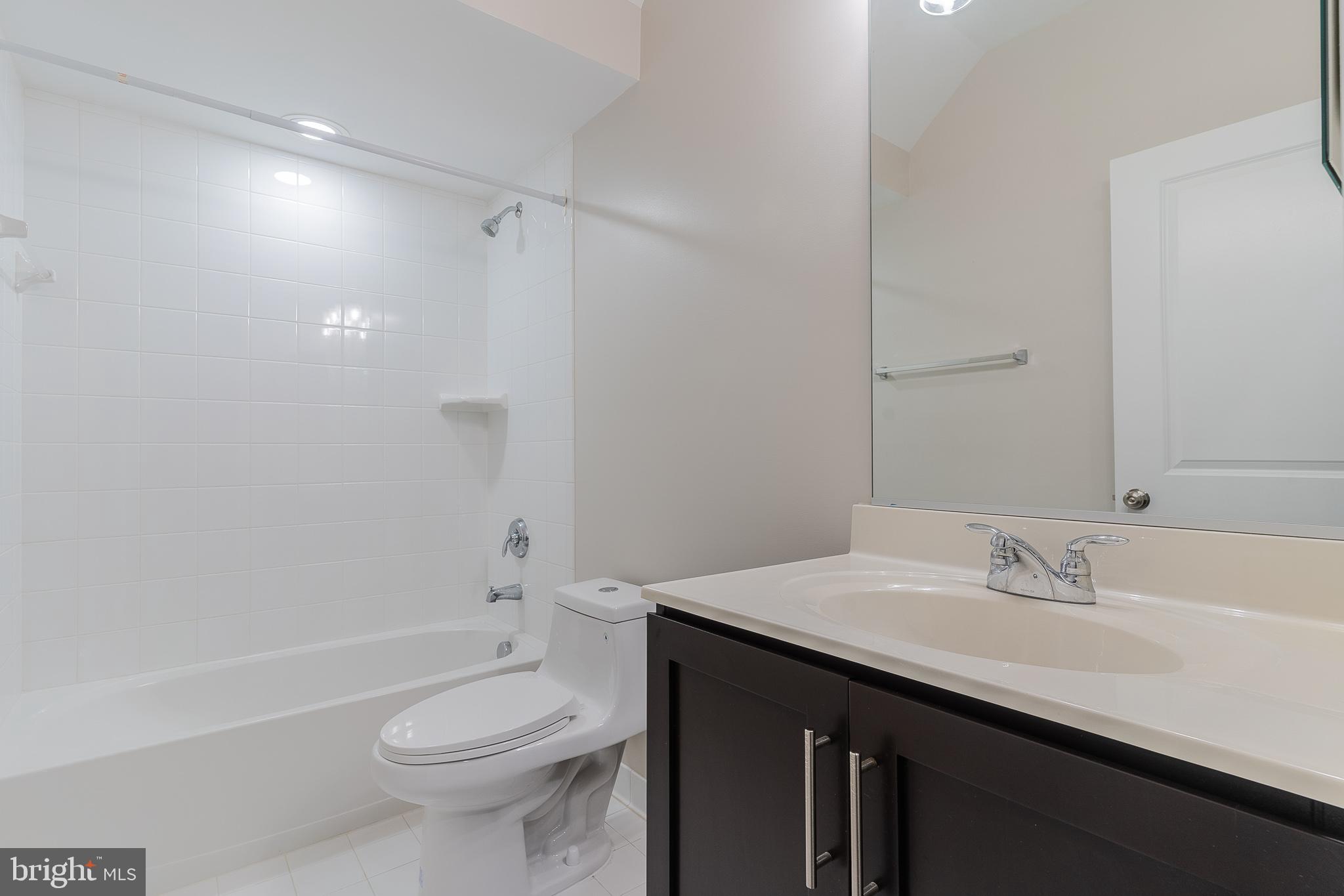 23480 Epperson Square Brambleton, VA 20148 - Photo 18 of 50 a bathroom with a sink a toilet and shower
