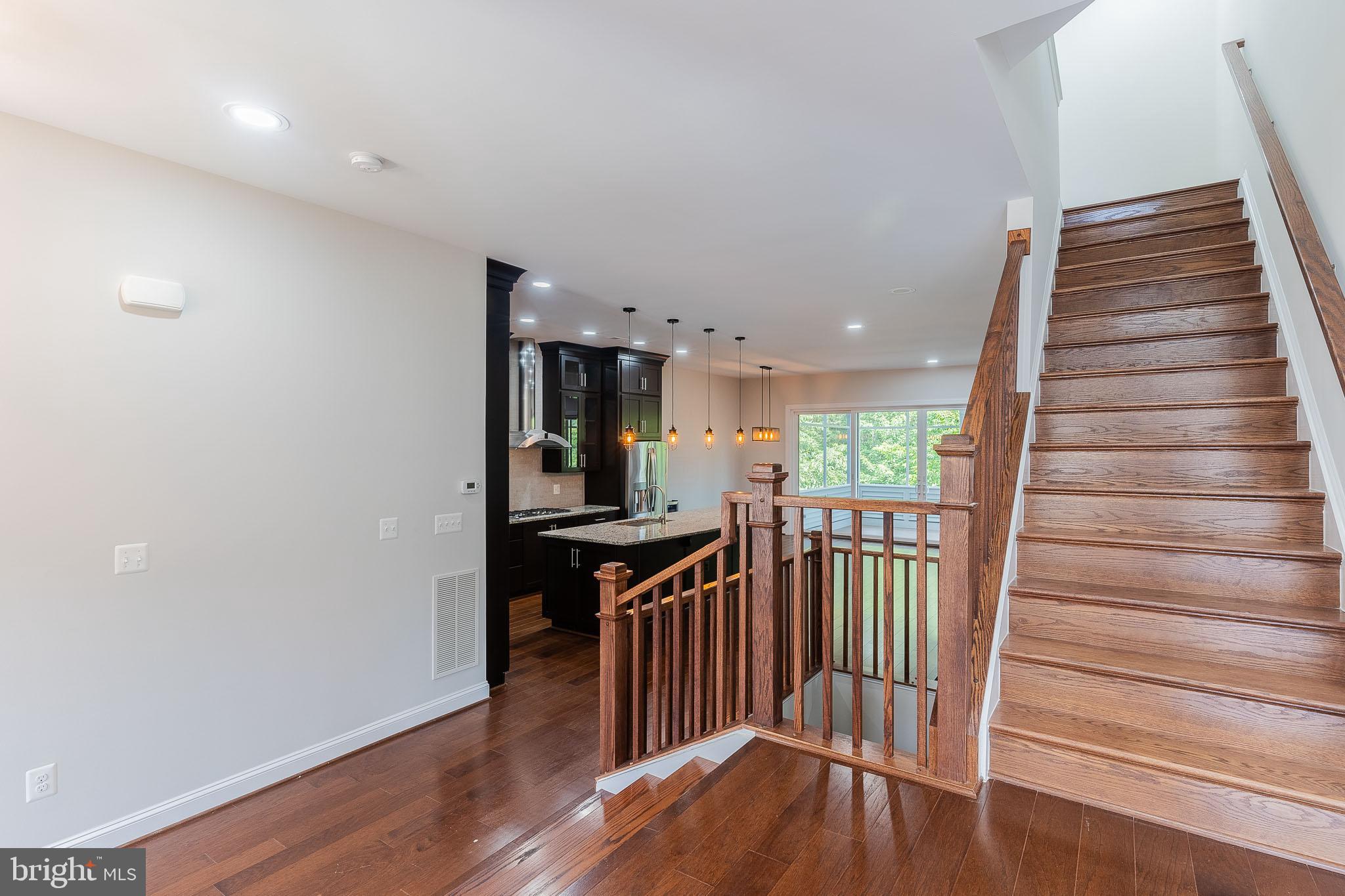 23480 Epperson Square Brambleton, VA 20148 - Photo 28 of 50 a view of a hallway with wooden floor and stairs