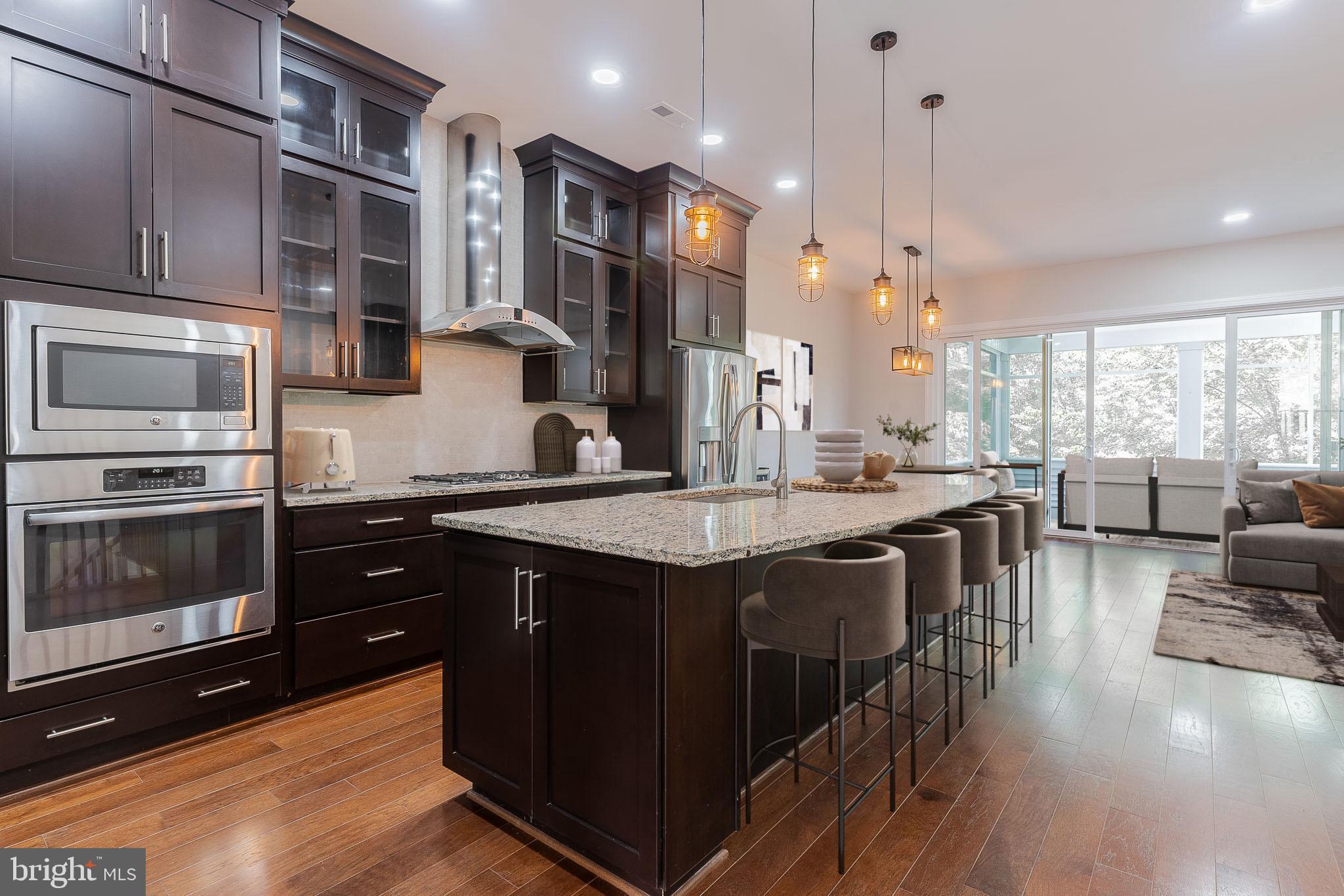 23480 Epperson Square Brambleton, VA 20148 - Photo 3 of 50 a kitchen with stainless steel appliances granite countertop a stove and a wooden floors