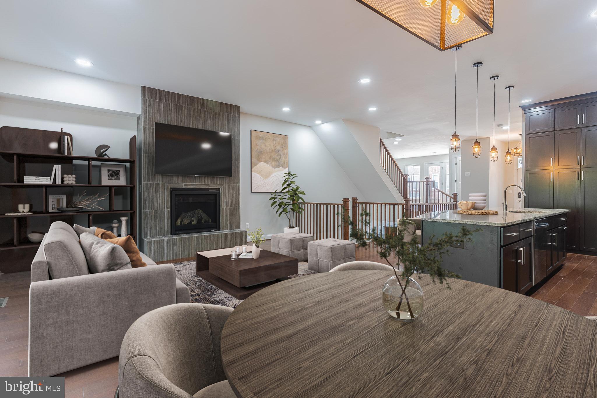 23480 Epperson Square Brambleton, VA 20148 - Photo 9 of 50 a living room with furniture kitchen view and a fireplace