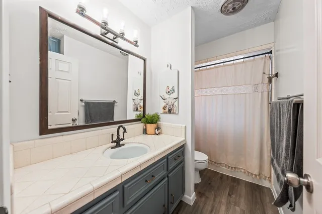 a bathroom with a sink double vanity granite and a mirror