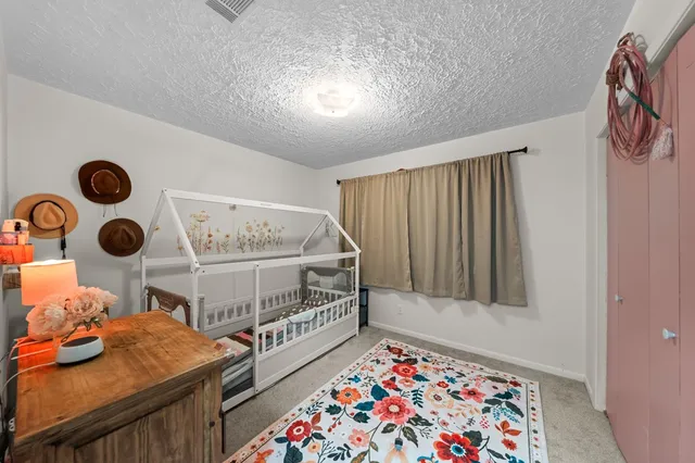 a bedroom with furniture and a window