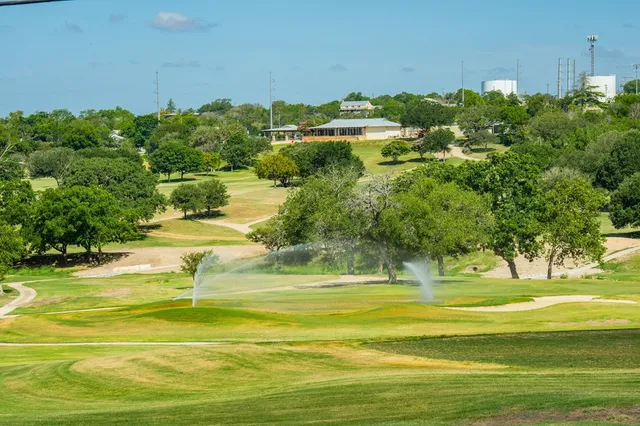 a view of a swimming pool with a yard