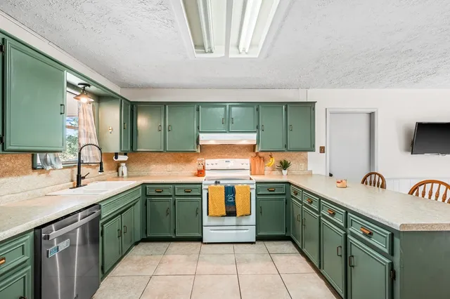 a kitchen with a sink stove and cabinets