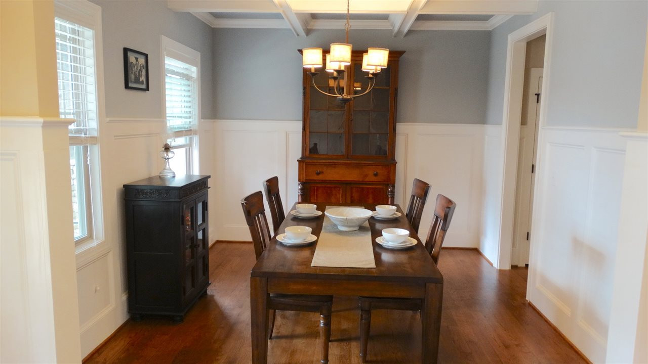 1308 Trinity Circle Raleigh, NC 27607 - Photo 8 of 25 Hardwood Floors, a Coffered Ceiling, Wainscoting, Elegant Chandelier, all make for a lovely place to serve your amazing meals. Dining Room