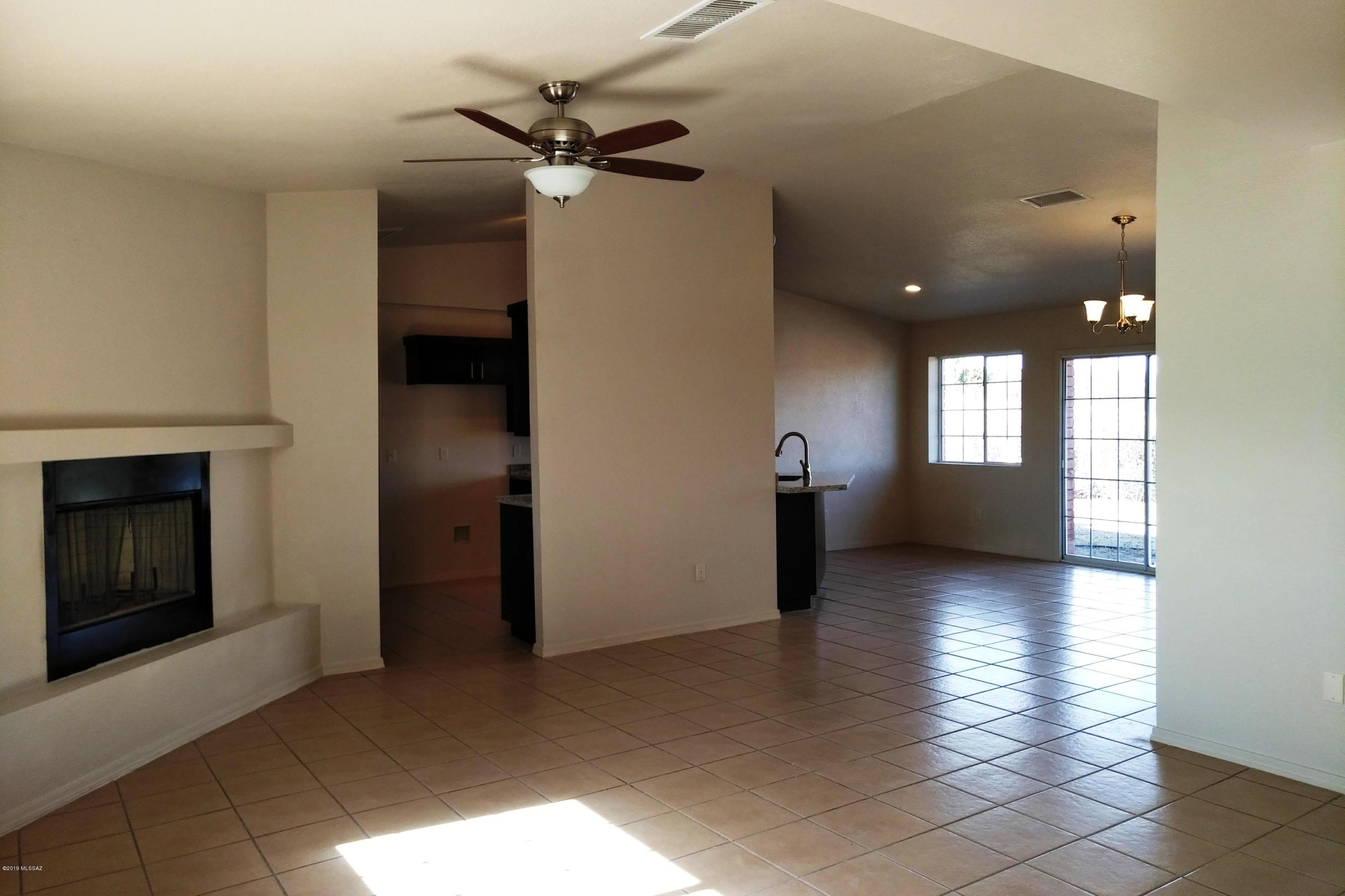 266 Mirto Court Rio Rico, AZ 85648 - Photo 22 of 22 an empty room with windows and fireplace