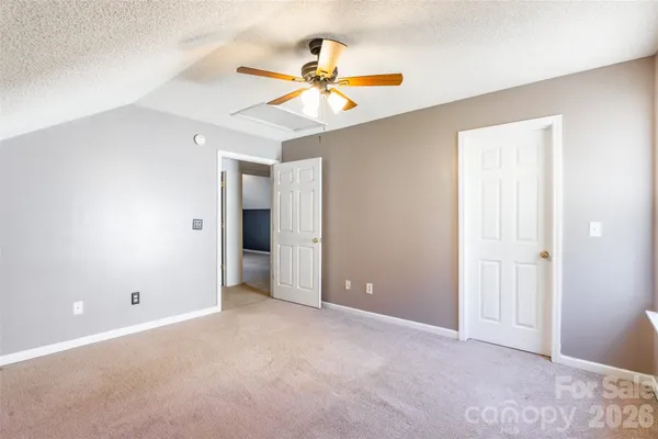 a view of an empty room with a ceiling fan