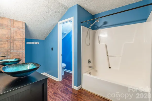 a bathroom with a tub and a sink