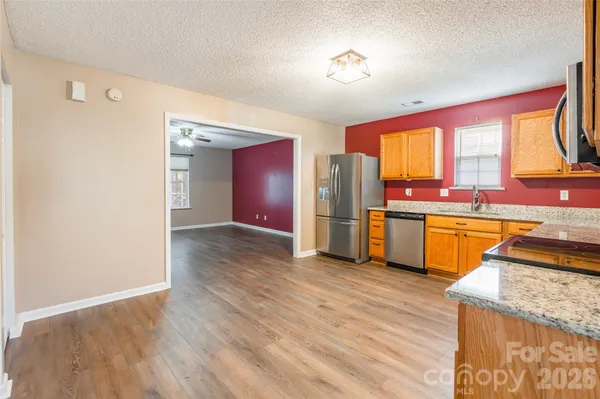 a kitchen with a sink a refrigerator and window
