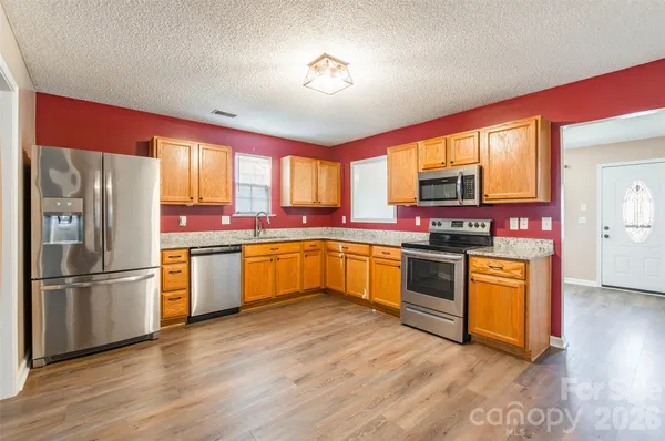 a kitchen with stainless steel appliances and window