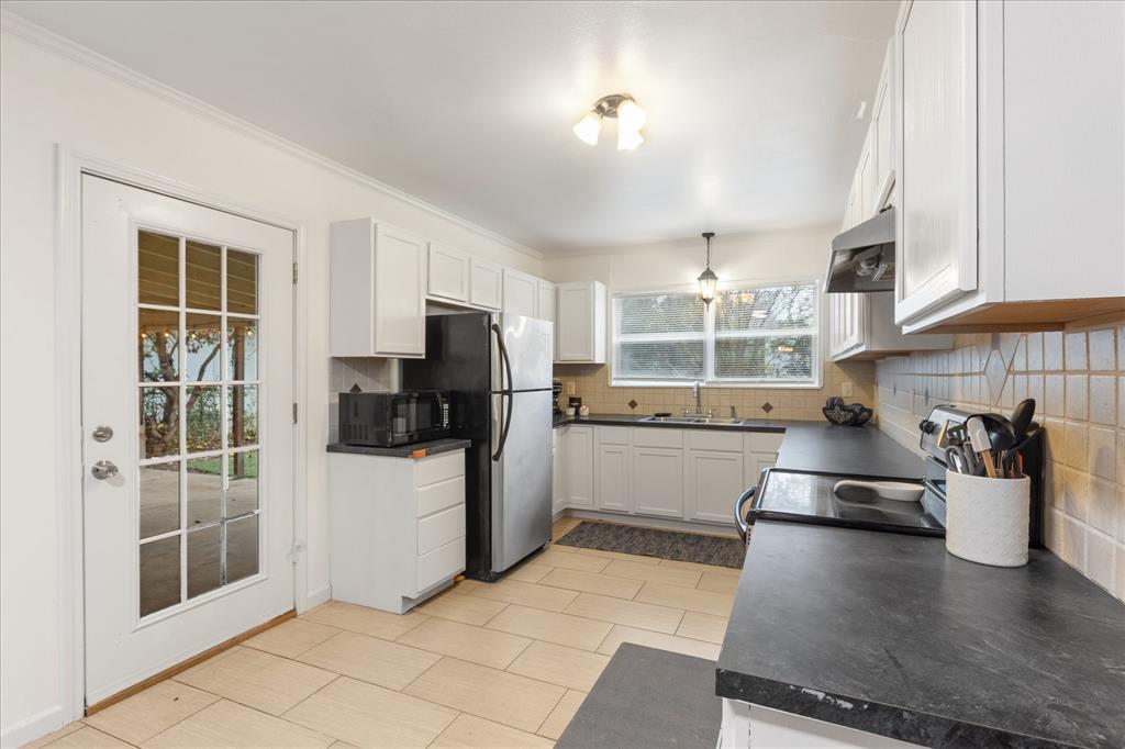 3554 Winston Road Fort Worth, TX 76109 - Photo 14 of 25 a kitchen with stainless steel appliances granite countertop a refrigerator and a sink