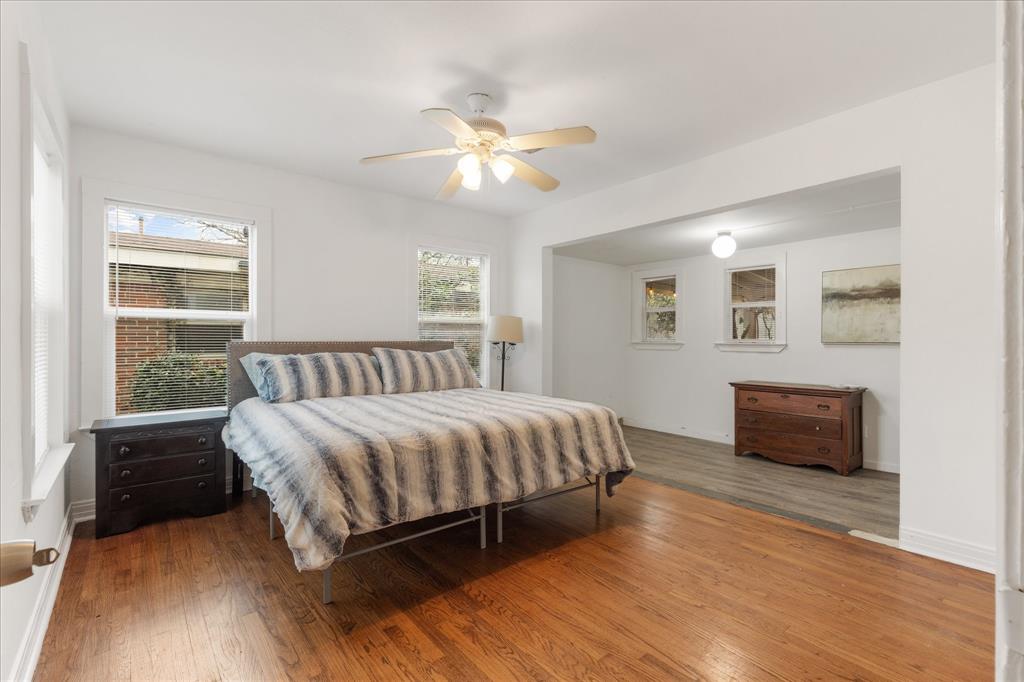 3554 Winston Road Fort Worth, TX 76109 - Photo 17 of 25 a spacious bedroom with a bed and wooden floor