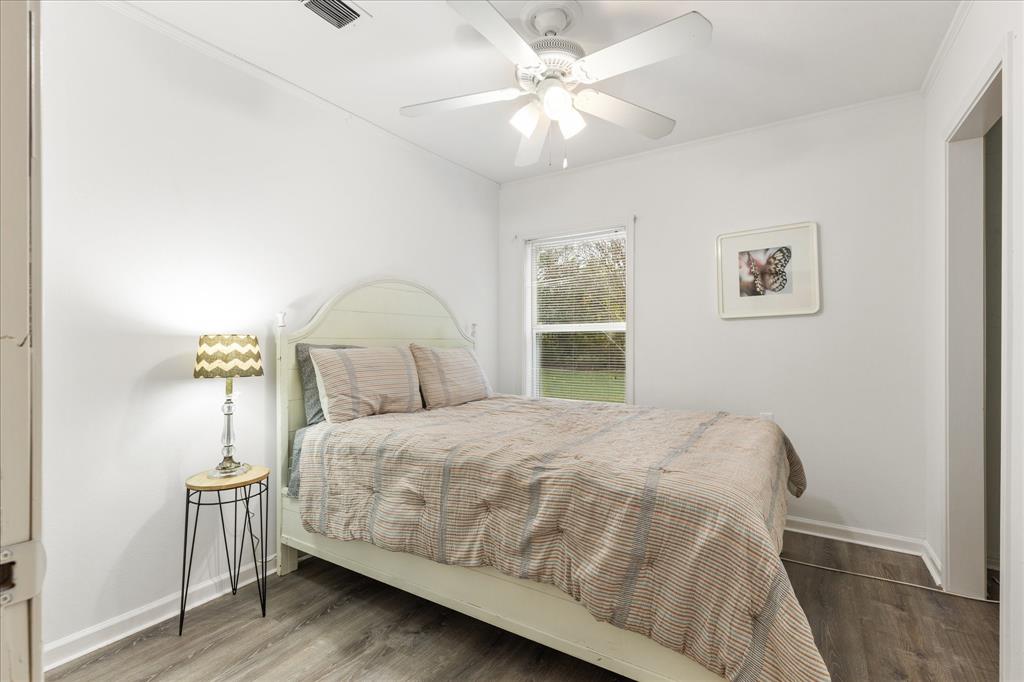 3554 Winston Road Fort Worth, TX 76109 - Photo 18 of 25 a bedroom with a bed next to a window with a chandelier