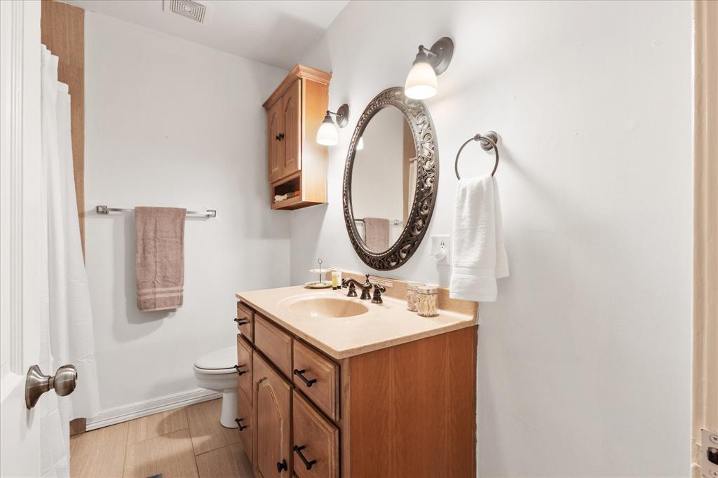 3554 Winston Road Fort Worth, TX 76109 - Photo 24 of 25 a bathroom with a sink and a mirror