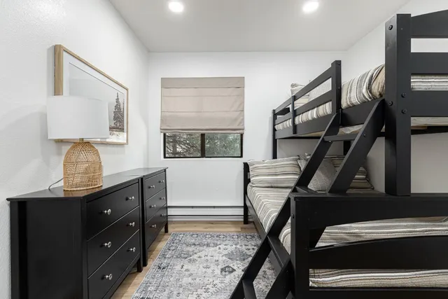 a bedroom with a bed and a large window