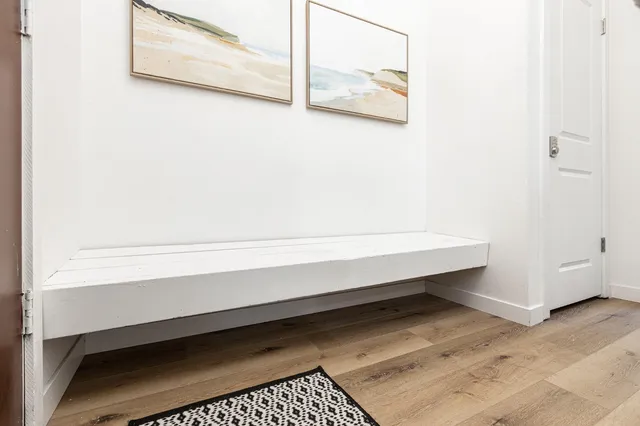 a kitchen with white cabinets and white appliances