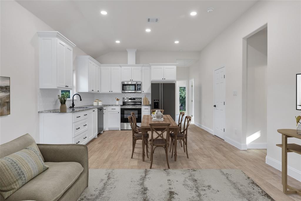 815 Southwest 28th Street Mineral Wells, TX 76067 - Photo 13 of 40 a view of kitchen with dining table and stainless steel appliances