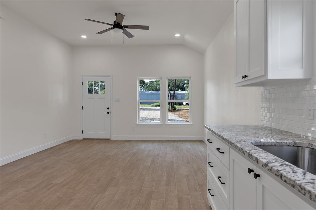 815 Southwest 28th Street Mineral Wells, TX 76067 - Photo 19 of 40 an empty room with windows and cabinet